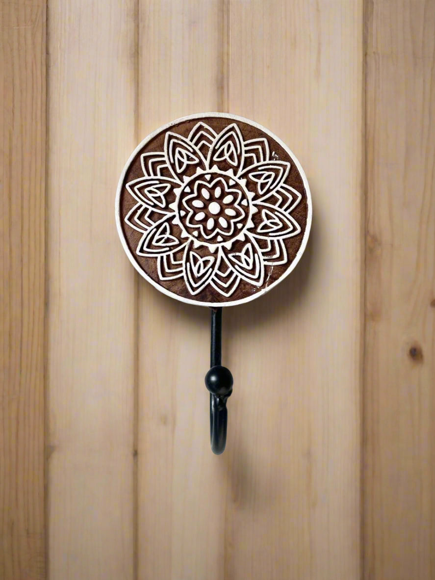 Wall hook with mandala design on a plain background